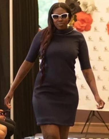 Model on runway in a navy blue 